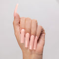 Hint of Pink cover acrylic powder applied to light-skinned hand