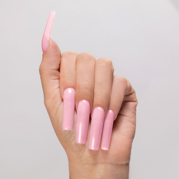 Pink Escape acrylic powder applied to light-skinned hand