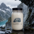 Candle jar with a mountain label in a natural setting