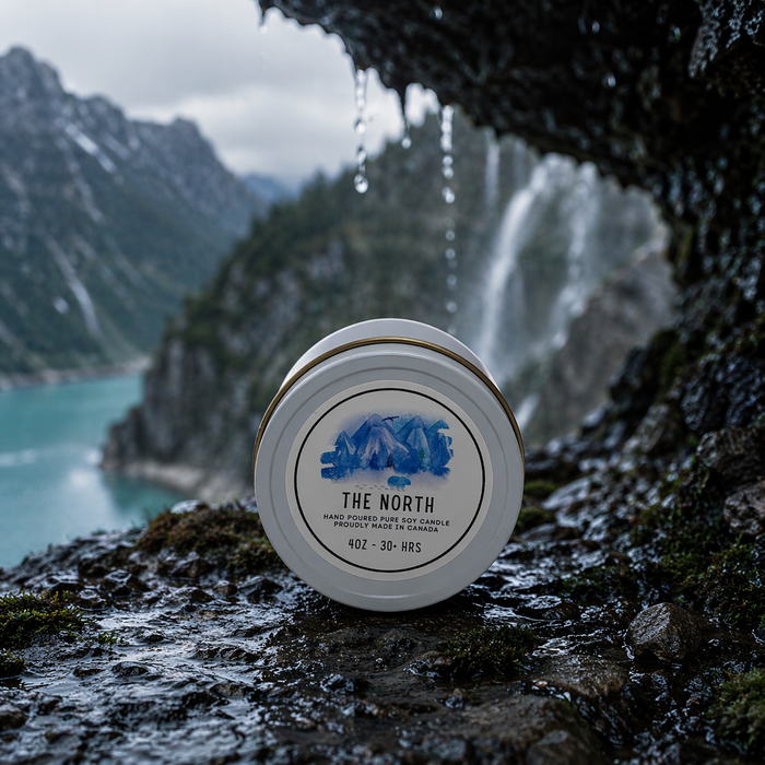 Candle labeled 'The North' on a rocky surface with a mountainous landscape in the background